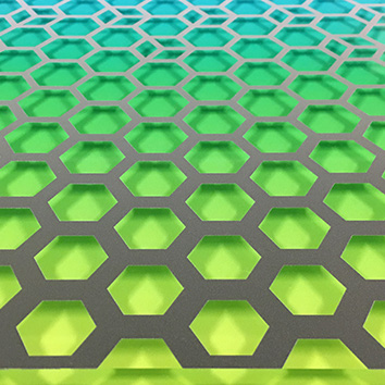 Image of a piece of acrylic printed with a colorful gradient on the bottom and a hexagon pattern on the top