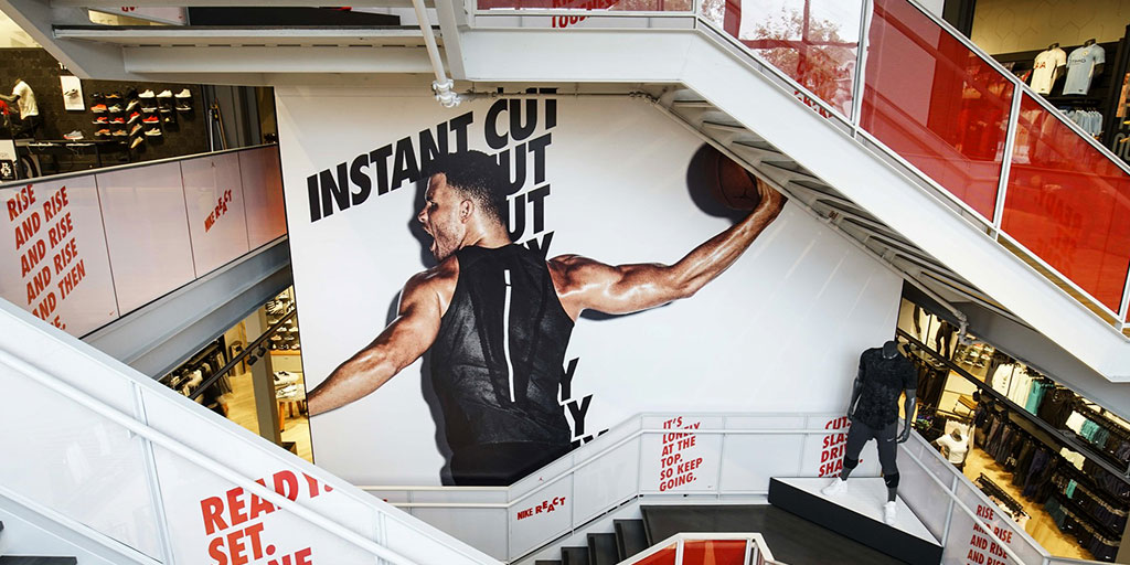 Image of three-story-tall stairwell graphic and matching graphic wraps on stairs