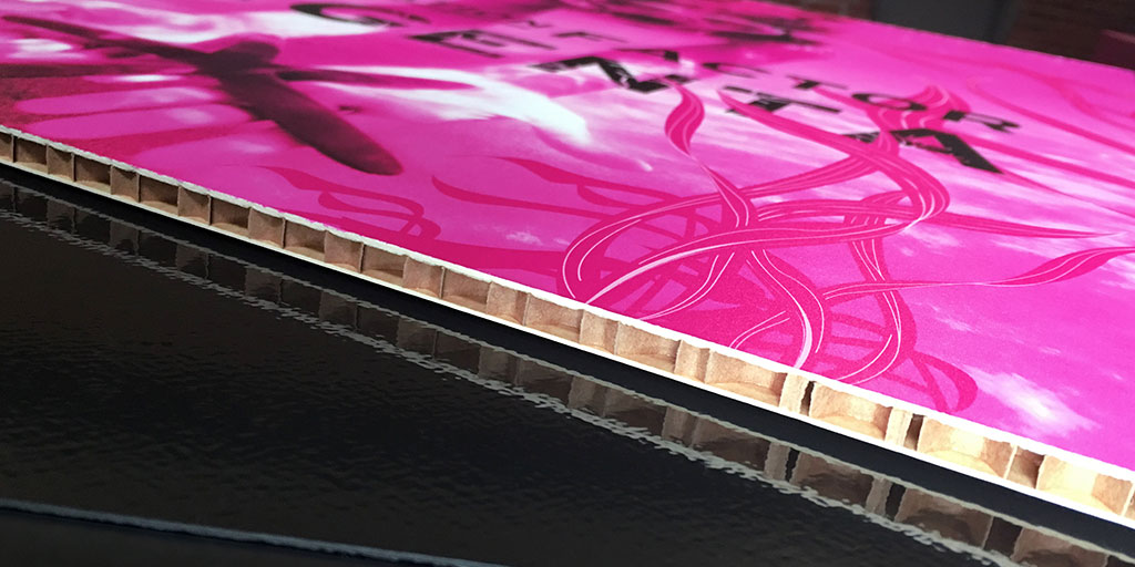 Image of the side of a magenta graphic printed on corrugated cardboard