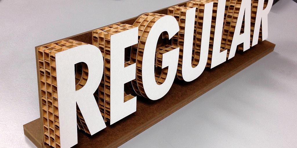 Image of the word "Regular" cut out of corrugated cardboard