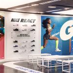 Image of a shoe display flanked by two large graphics and custom floor vinyl as part of a national graphic roll out