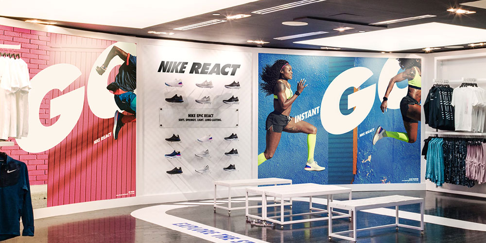 Image of a shoe display flanked by two large graphics and custom floor vinyl as part of a national graphic roll out