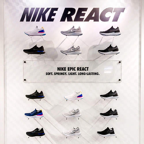 Image of a shoe display wall with custom acrylic sign as part of a national graphic roll out