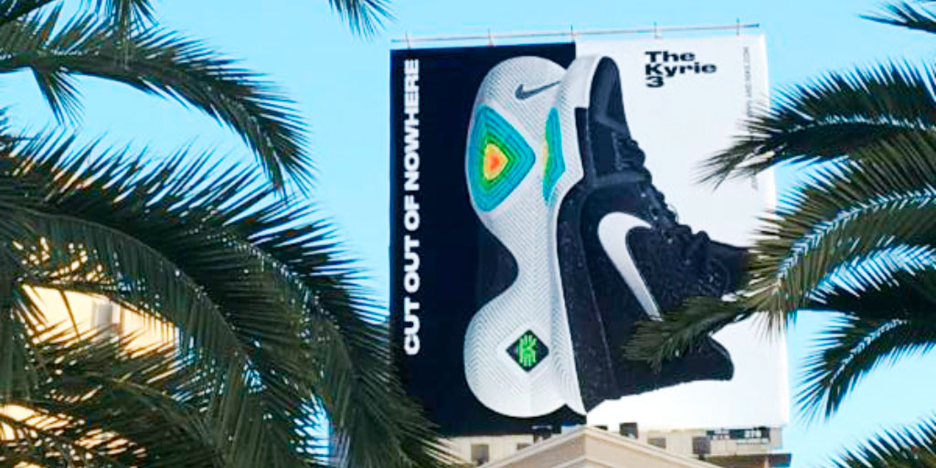 Image of an outdoor billboard featuring a shoe with a colorful sole