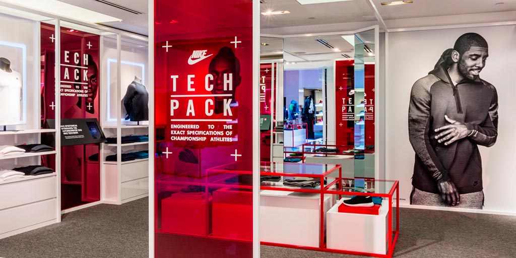 Image of a retail display with wall-sized red acrylic printed graphics